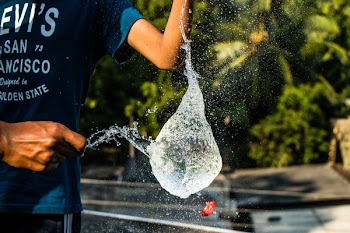 Person in Black Shirt Pouring Water