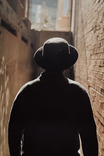 person in black sun hat