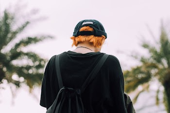 Person in Black Top Wearing Backpack Outdoors