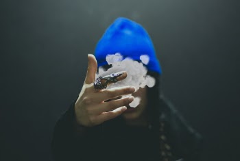 Person in Blue Cap Raising It's Hand