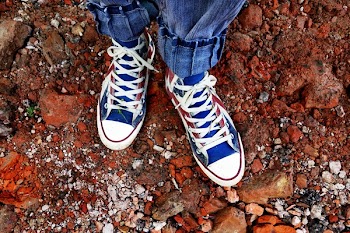 Person in Blue Denim Jeans in Blue and White Sneakers