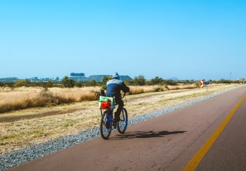 Person In Blue Jacket Riding Bicycle