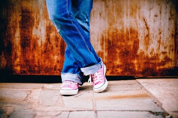 Person in Blue Jeans and Pink White Converse All Star Sneakers