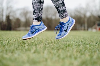 person in blue Nike sneaker jumping