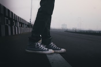 Person In Blue Sneakers Standing On Road