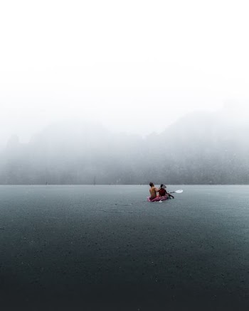 person in boat on body of water