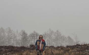 Person in Brown and Red Scarf