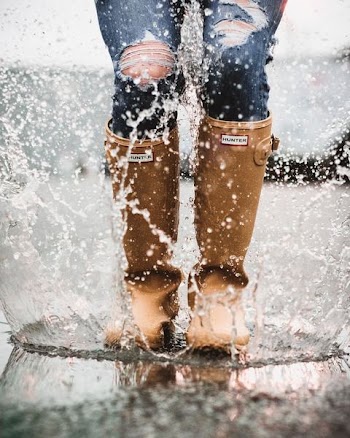 person in brown Hunter rain boots