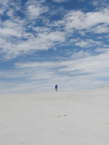 Person in Dessert Under Cloudy Sky