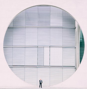 Person in Front of Gray Structure