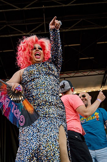 Person in Pink Hair and One-shoulder Fitted Slit Dress Holding Hand Fan