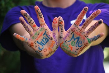 Person in Purple Crew Neck T Shirt With Just Me Painting on Hand