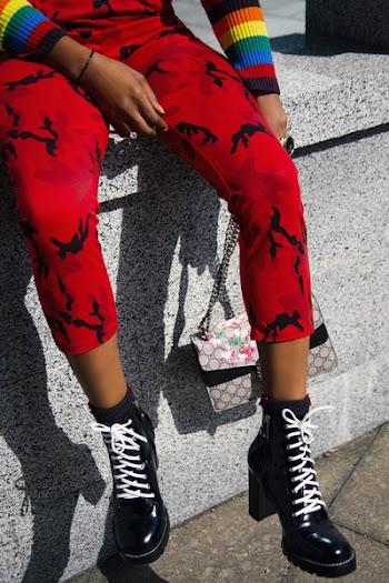 Person in Red Pants and Pair of Black Heeled Boots