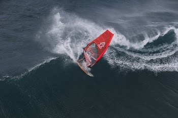 Person in Surfboard in the Wave during Daytime