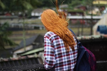 Person in White and Red Checkered Top With Black and Red Backpack in Shallow Focus Photography