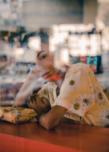 Person in White and Yellow Floral Dress