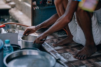 Person In White Shorts Holding Stainless Steel Casserole