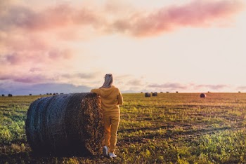 Person In Yellow Hoodie On Grass Field