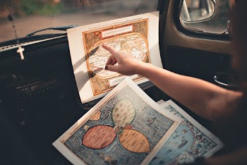 Person Inside A Vehicle Pointing On A Map 