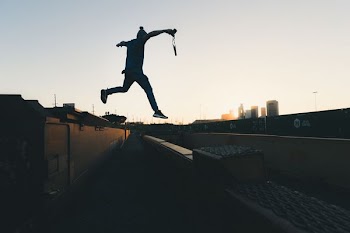 person jump through building
