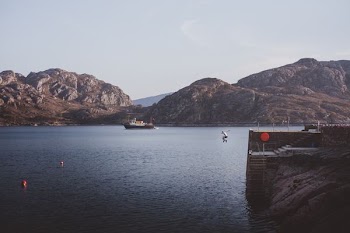 person jumping on body of water