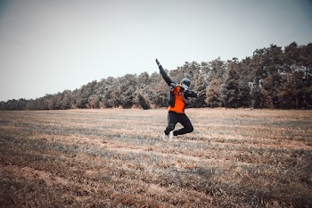 Person Jumping over Grass