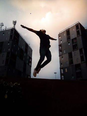 Person Jumping With Arms Wide Open
