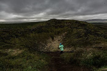 Person Kneeling on Green and Black Field