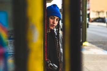 Person Leaning on Yellow Wall