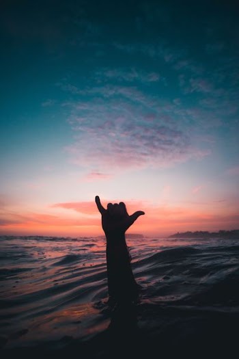 person lifting his hand from water