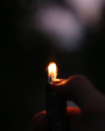 person lighting lighter