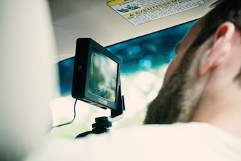 Person Looking at Black Vehicle Camera