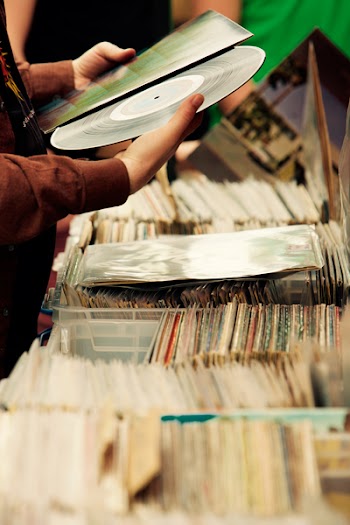 Person Looking at Vinyl Disc