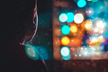 Person Looking Outside With Bokeh Lights
