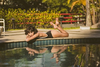 Person Lying Down Beside Pool