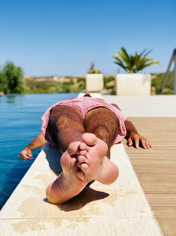 Person Lying Down Beside Swimming Pool