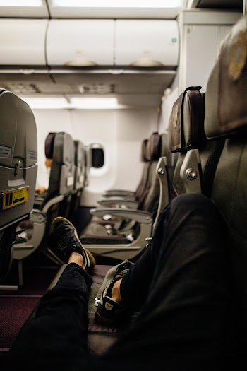 Person Lying Down on Airline Seats