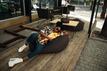 Person Lying on Bean Bag Chair
