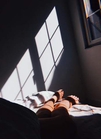Person Lying On Bed Inside Room