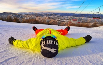 Person Lying on Snow Ground