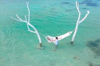 Person Lying on White Hammock