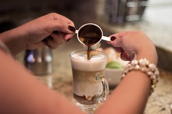 Person Making a Cappuccino Coffee