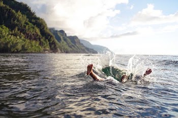 person on water under gray sky