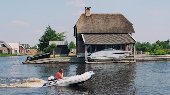 Person on White Inflatable Speed Boat