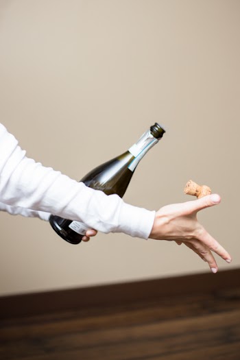 Person Opening Champagne Bottle