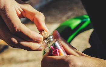 Person Opening Glass Bottle