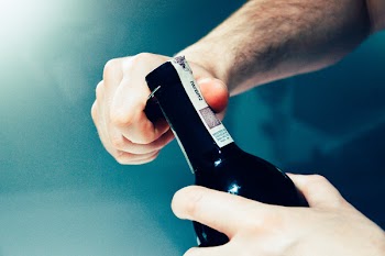 Person Opening the Bottle