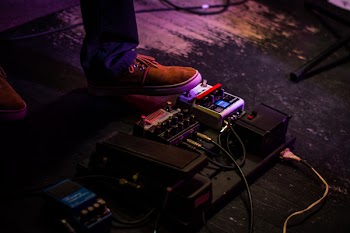 Person Operating Guitar Effects Pedal