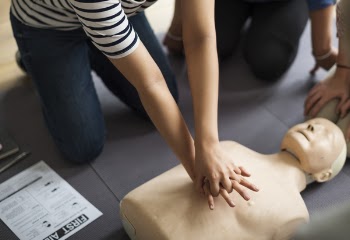 Person Performing CPR On Dummy