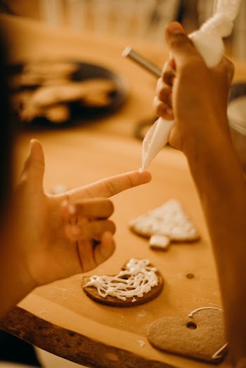 Person Piping Icing on His Finger